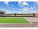 View of a backyard area with artificial turf, patio and a low wall fence at 10431 E Tiger Lily Ave, Mesa, AZ 85212