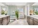 Modern bathroom featuring dual vanities, a glass-enclosed shower, and a freestanding soaking tub at 10431 E Tiger Lily Ave, Mesa, AZ 85212