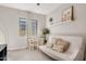 Bright bedroom featuring a futon, desk with chair, a window, and art on the wall, creating a welcoming space at 10431 E Tiger Lily Ave, Mesa, AZ 85212