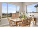 Bright dining room with large windows and a view of the landscaped backyard at 10431 E Tiger Lily Ave, Mesa, AZ 85212