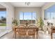 Bright dining area featuring light wood floors and large windows with natural light at 10431 E Tiger Lily Ave, Mesa, AZ 85212