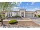 Charming single-story home featuring a well-manicured yard, neutral tones, and an attached two-car garage at 10431 E Tiger Lily Ave, Mesa, AZ 85212