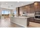 Kitchen with stone countertops, stainless steel appliances, and views of the dining area at 10431 E Tiger Lily Ave, Mesa, AZ 85212