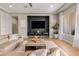 Comfortable living room featuring hardwood floors, a black accent wall, and stylish furniture at 10431 E Tiger Lily Ave, Mesa, AZ 85212