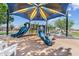 Community playground with colorful slides, climbing structures, and shade structures for to play at 10431 E Tiger Lily Ave, Mesa, AZ 85212