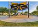 Community playground with climbing structures, slides, and a shaded area for outdoor fun at 10431 E Tiger Lily Ave, Mesa, AZ 85212