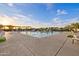 Community swimming pool with lounge chairs and shade structures, perfect for relaxation and recreation at 10431 E Tiger Lily Ave, Mesa, AZ 85212