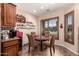 Eat-in kitchen area features a window with plantation shutters and space for four at 11062 E Ocaso Ave, Mesa, AZ 85212