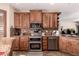 The kitchen has stainless steel appliances, wooden cabinetry, and a tiled backsplash at 11062 E Ocaso Ave, Mesa, AZ 85212