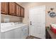 Functional laundry room features modern appliances, ample cabinetry, and access to the garage at 11062 E Ocaso Ave, Mesa, AZ 85212