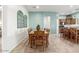 Dining room area with decorative window and wood table with chairs at 11121 E Onza Ave, Mesa, AZ 85212