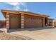 Spacious two-car garage featuring a wide driveway and mature desert landscaping at 11121 E Onza Ave, Mesa, AZ 85212