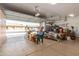 Open garage with epoxy flooring offers plenty of space for parking and projects with natural light at 11121 E Onza Ave, Mesa, AZ 85212