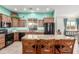 Stylish kitchen featuring an island with barstool seating and stainless steel appliances at 11121 E Onza Ave, Mesa, AZ 85212