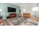 Inviting living room featuring colorful rug, comfortable seating, and decorative furnishings at 11121 E Onza Ave, Mesa, AZ 85212