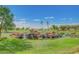 Scenic water feature with rock waterfall enhances the lush green golf course landscape and community charm at 11121 E Onza Ave, Mesa, AZ 85212