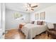 Bedroom boasting a ceiling fan, window, wood-look flooring, and an inviting, neatly arranged bed at 11446 W Hidalgo Ave, Tolleson, AZ 85353