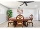 Elegant dining room with decorative wood table and chairs, complemented by a ceiling fan and natural light at 11446 W Hidalgo Ave, Tolleson, AZ 85353