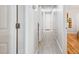 Long, bright hallway with wood-look flooring showcases neutral walls and multiple access doors at 11446 W Hidalgo Ave, Tolleson, AZ 85353