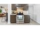 Close-up of kitchen featuring stainless steel oven, dark cabinets, and tiled backsplash at 11446 W Hidalgo Ave, Tolleson, AZ 85353