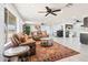 Spacious living room featuring neutral walls, modern ceiling fan, and stylish furniture arrangement at 11446 W Hidalgo Ave, Tolleson, AZ 85353