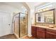 Bright bathroom with glass shower, granite countertop, and oversized framed mirror at 12708 W Auburn Dr, Peoria, AZ 85383