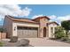 Charming single Gathering home displaying desert landscaping, solar panels, and a brick embellished archway entry at 12708 W Auburn Dr, Peoria, AZ 85383