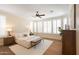 Bright main bedroom features neutral decor, hardwood floors, a ceiling fan, and large windows with stylish shutters at 12708 W Auburn Dr, Peoria, AZ 85383