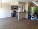 A well-lit kitchen and living space featuring dark cabinets and modern stainless steel appliances at 14259 N Oakwood W Ln, Fountain Hills, AZ 85268