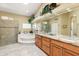 Luxurious bathroom featuring a glass shower, and a soaking tub at 15385 W Indianola Ave, Goodyear, AZ 85395