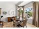 Charming dining area with backyard view, chandelier, and stylish wooden buffet at 15385 W Indianola Ave, Goodyear, AZ 85395