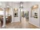 Elegant foyer featuring tile flooring, arched doorways, and an open floor plan flowing into dining and living areas at 15385 W Indianola Ave, Goodyear, AZ 85395