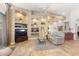 Living room featuring tile flooring, a ceiling fan, and recessed shelving at 15385 W Indianola Ave, Goodyear, AZ 85395