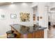 Wet bar with granite countertops and dark wood cabinetry at 15385 W Indianola Ave, Goodyear, AZ 85395