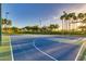 Well-maintained basketball court surrounded by palm trees and greenery offers recreational opportunities for residents at 17743 W Verdin Rd, Goodyear, AZ 85338