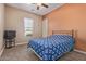 Cozy bedroom featuring neutral carpet, ceiling fan, and a window with outside views at 17743 W Verdin Rd, Goodyear, AZ 85338