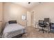 Bedroom with soft carpet offers a desk, comfortable chair, and a bed with cozy bedding at 17743 W Verdin Rd, Goodyear, AZ 85338