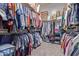 Spacious walk-in closet with custom shelving and plentiful hanging storage to organize any wardrobe at 17743 W Verdin Rd, Goodyear, AZ 85338