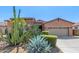 Charming home featuring desert landscaping, rock accents, and a two-car garage at 17743 W Verdin Rd, Goodyear, AZ 85338