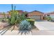 Charming home featuring desert landscaping, rock accents, and a two-car garage at 17743 W Verdin Rd, Goodyear, AZ 85338