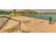 Recreational horseshoe pit near a calm lake, offering a relaxing outdoor activity in a serene community setting at 17743 W Verdin Rd, Goodyear, AZ 85338