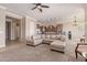 Spacious living room with a neutral color palette and plush carpeting, great for entertaining and relaxing at 17743 W Verdin Rd, Goodyear, AZ 85338