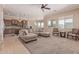 Open-concept living room with neutral carpet and plenty of natural light at 17743 W Verdin Rd, Goodyear, AZ 85338