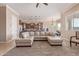 Open-concept living room featuring a large sectional sofa, and seamless transition to the kitchen at 17743 W Verdin Rd, Goodyear, AZ 85338