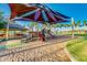 Colorful playground with sunshade, slides and palm trees providing a fun and safe play area in a beautiful community at 17743 W Verdin Rd, Goodyear, AZ 85338