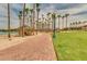 Brick walking path lined with palm trees, street lamps and community pavilions at 17743 W Verdin Rd, Goodyear, AZ 85338