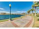 Lakeside walking path with palm trees, street lamps, and water views at 17743 W Verdin Rd, Goodyear, AZ 85338