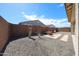 This low-maintenance backyard features desert landscaping, a privacy fence and an outdoor seating area at 17893 W Indigo Brush Rd, Goodyear, AZ 85338