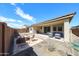 The fenced backyard features a patio under a covered area, landscaping, and outdoor seating at 17893 W Indigo Brush Rd, Goodyear, AZ 85338