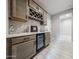 Bar with wine rack, wine glass rack, mini fridge and wood-look tile flooring at 17893 W Indigo Brush Rd, Goodyear, AZ 85338